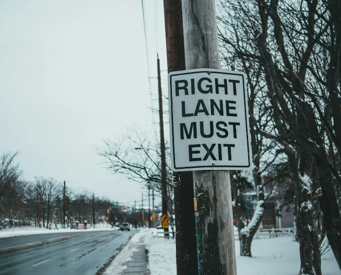 white and black stop road sign